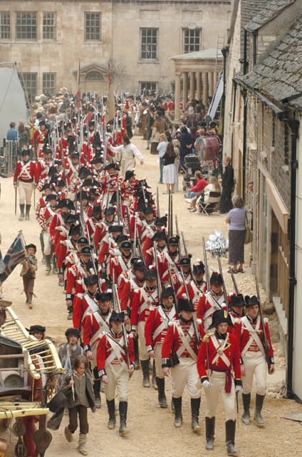 Behind-the-scenes view of Pride and Prejudice (2005) filming – militia extras marching through Stamford, Lincolnshire streets