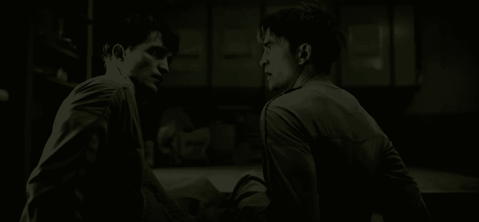 film still from Mickey 17 showing Robert Pattinson looking at another embodiment of himself