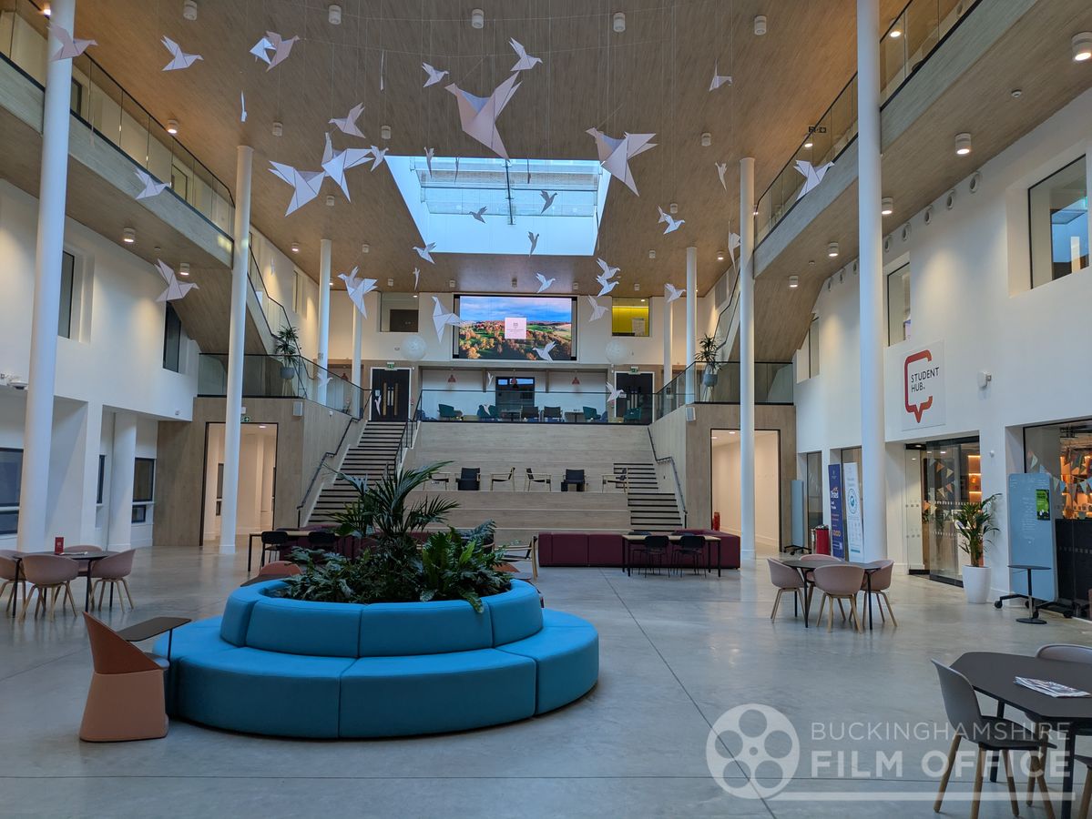 Large modern interior with clinical corridors and signage in Buckinghamshire — doubles as a hospital or airport for film and TV