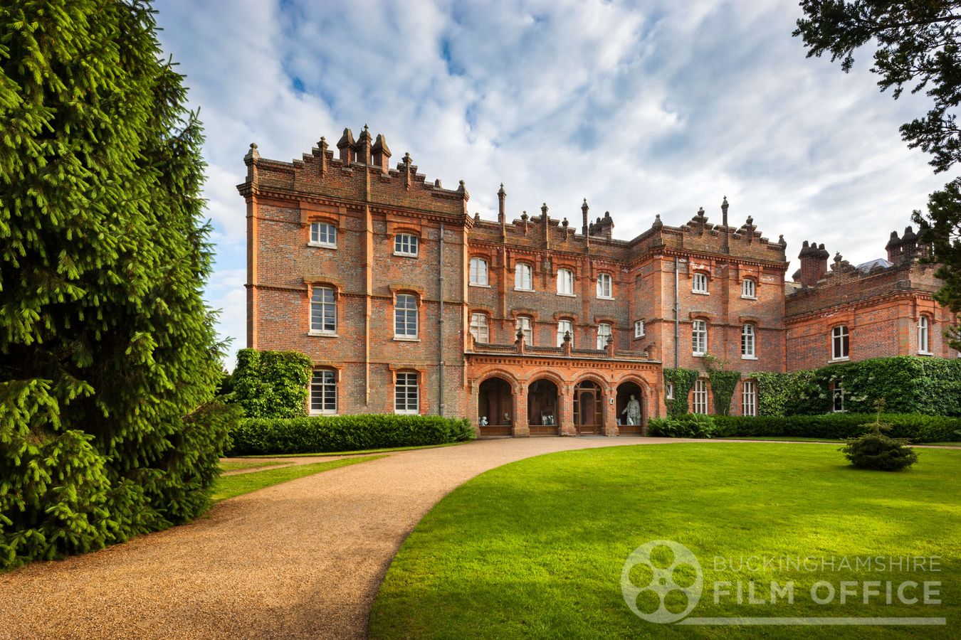 Victorian country house with sweeping lawn and ornate brick facade in Buckinghamshire