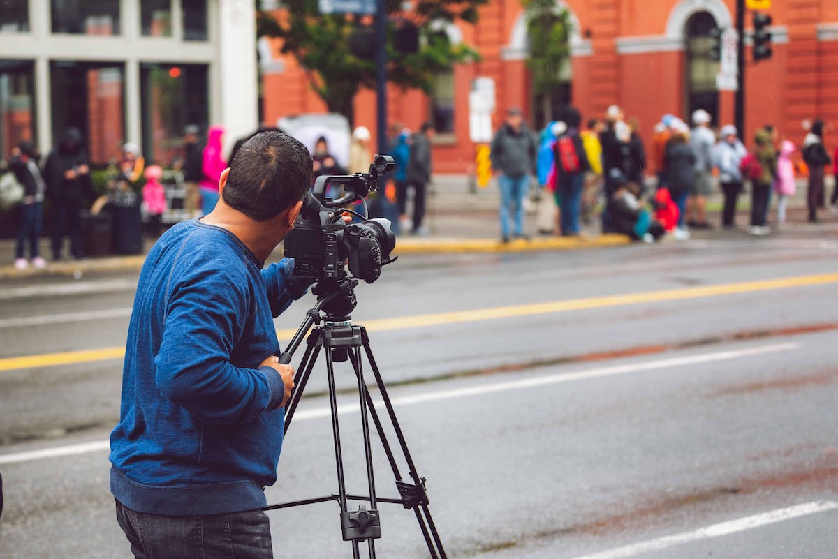 image of a man filming a busy street