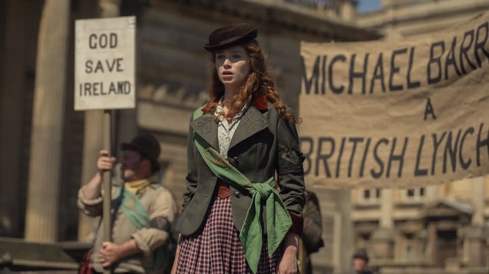 Film still from House of Guiness showing a female characater at a protest